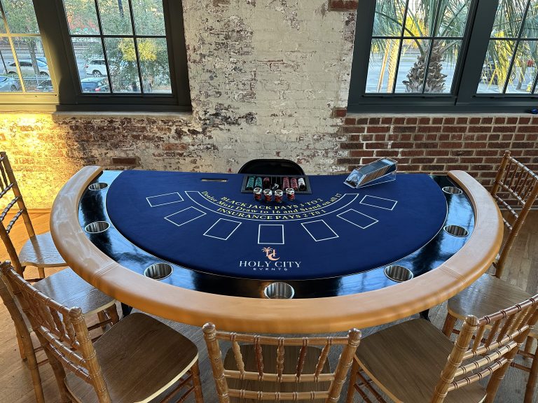 Blackjack table and chairs in an indoor event setting from the Holy City Events portfolio